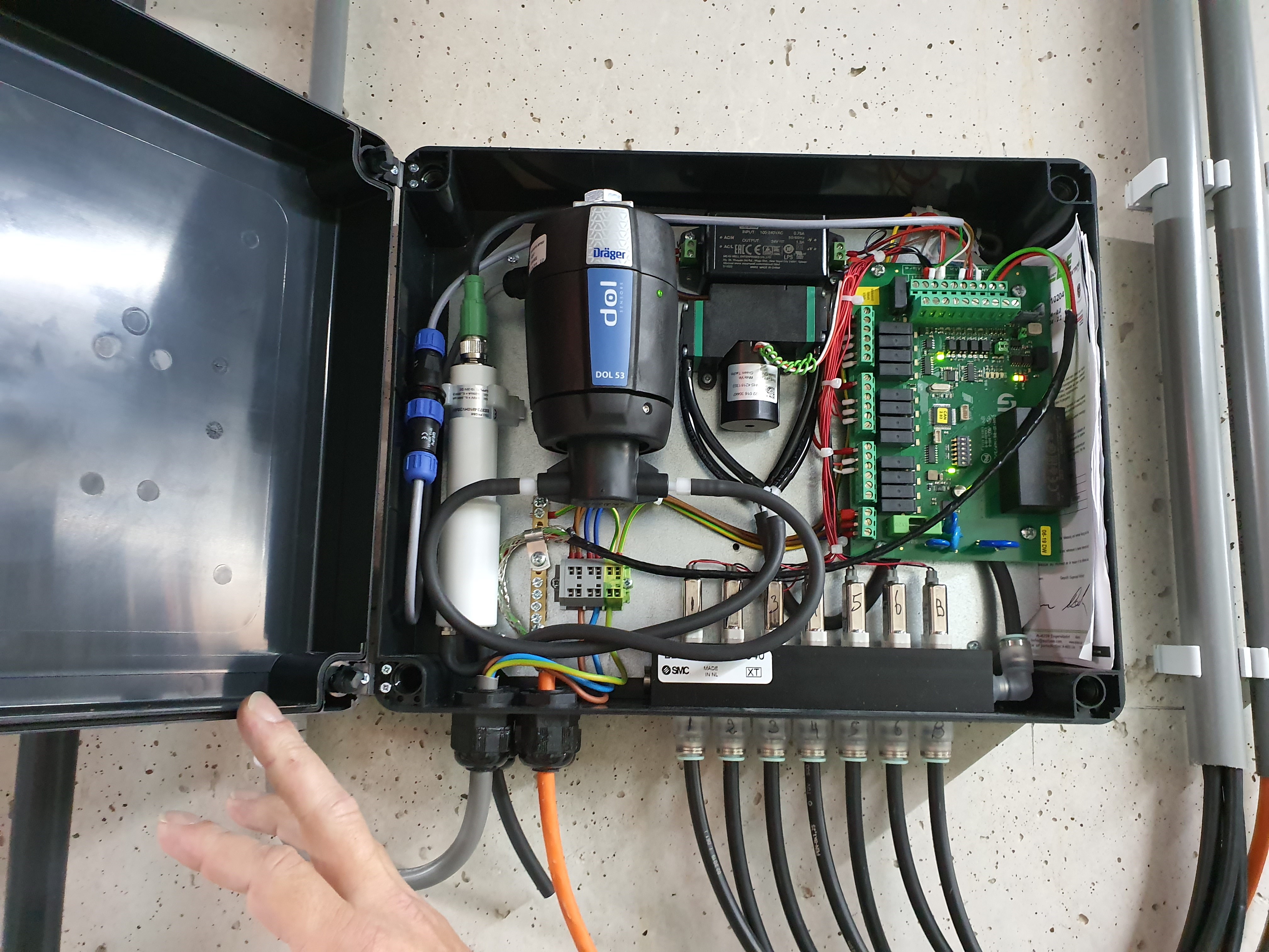 In dit kastje zitten de CO2- en NH3-meters. Via de slangen wordt de lucht uit 1 van de 6 afdelingen aangezogen. De 7de slang is voor het ijken met verse buitenlucht. 